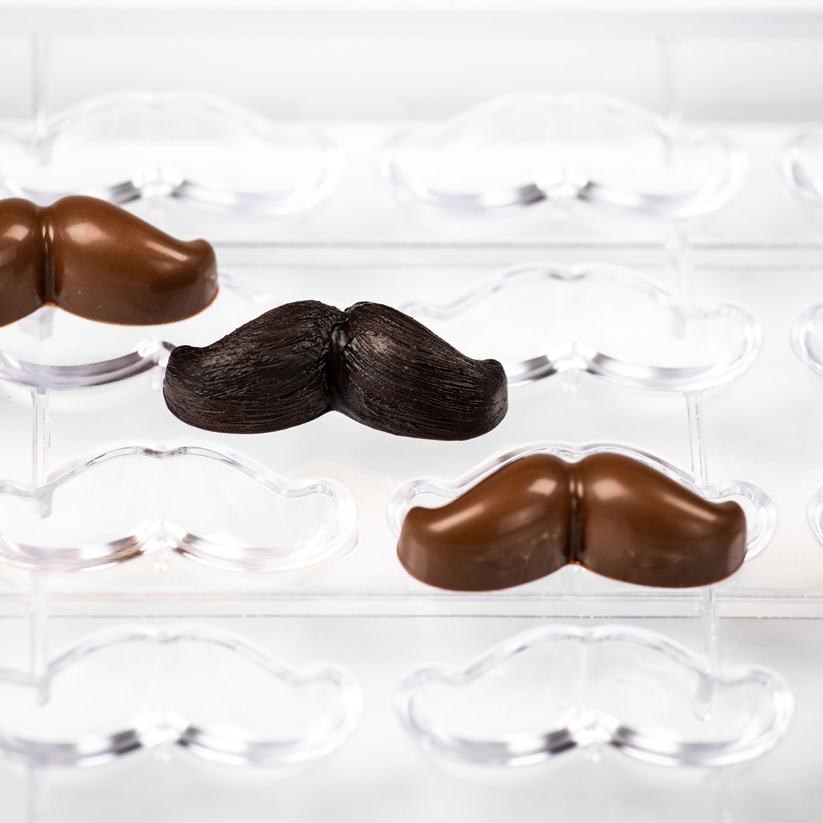 https://www.pastrychefsboutique.com/26102/martellato-ma1053-professional-polycarbonate-joe-mustache-chocolate-mold-16mm-x-54mm-x-h-16mm-10gr-16-cavity-themed-molds.jpg